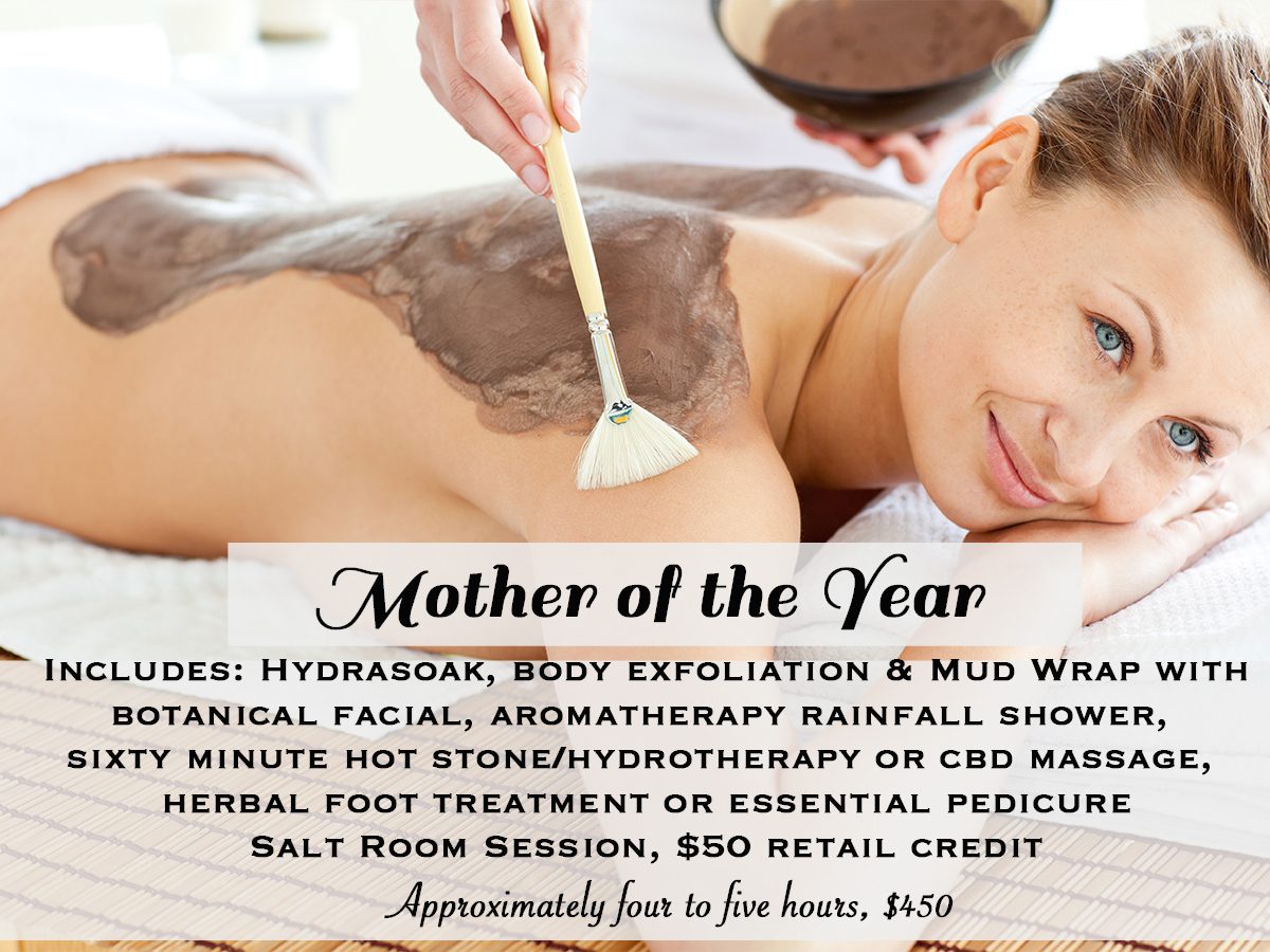 A woman getting her body waxed at the spa